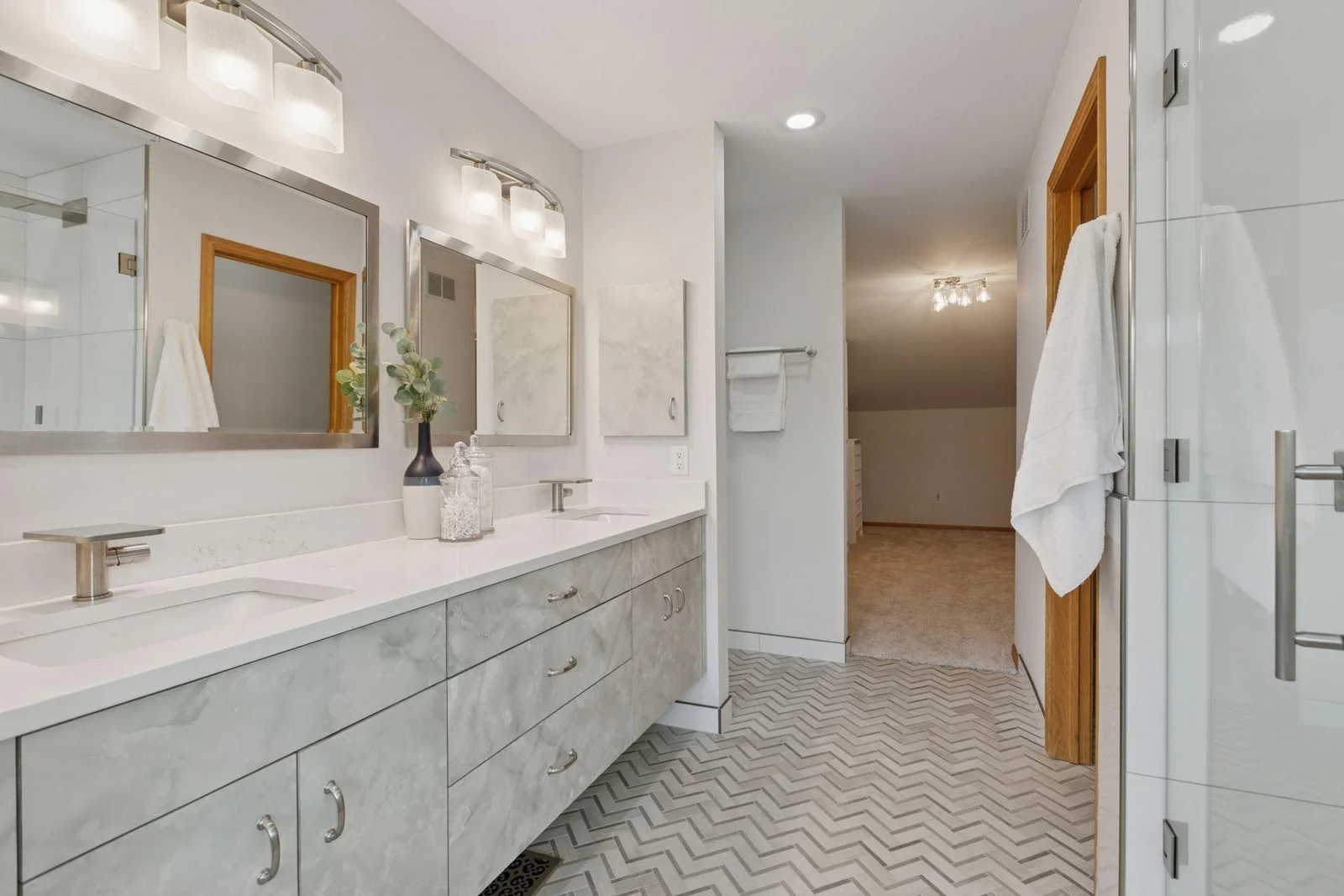 The custom double vanity has modern fixtures and soft-close cabinets