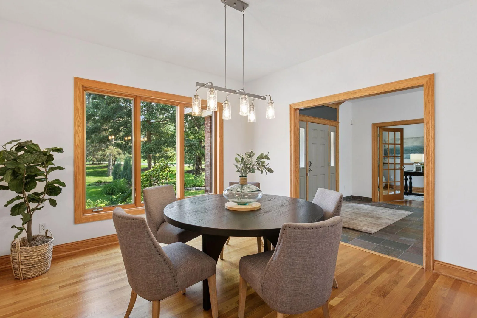 Large dining room with modern sconces and chandelier