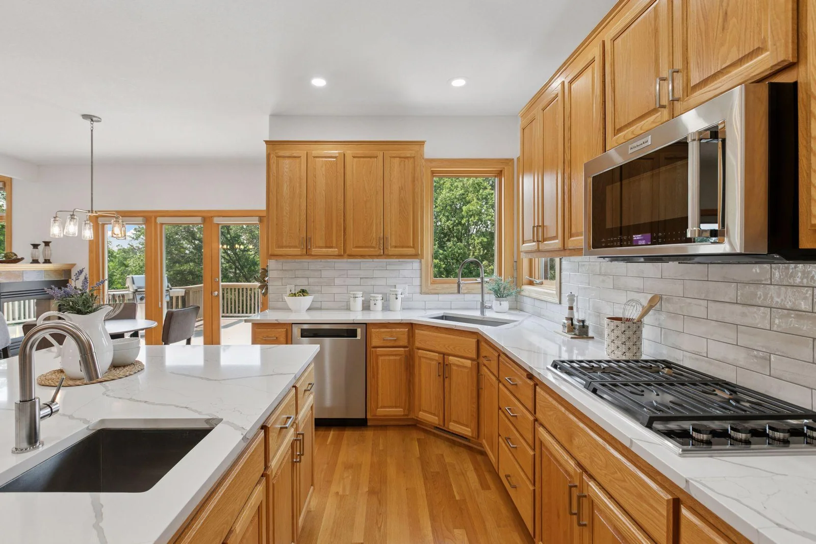 The kitchen features two sinks and a Wolf gas cooktop
