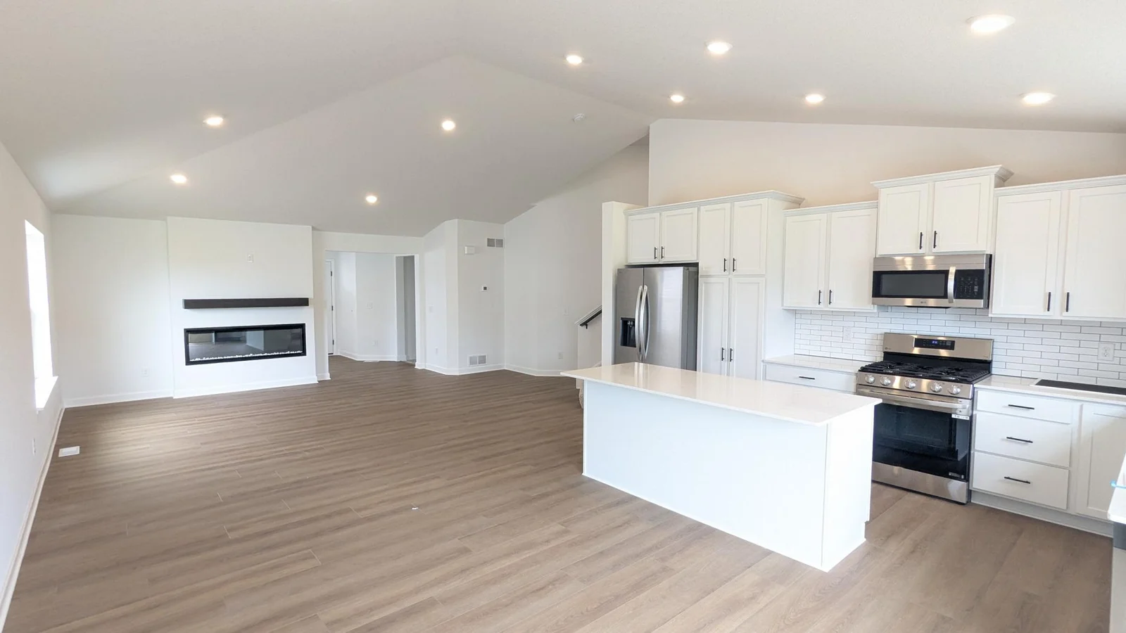 Photo of the actual home as of 6.29! The kitchen island with quartz countertops and the electric fireplace are features that are sure to impress.