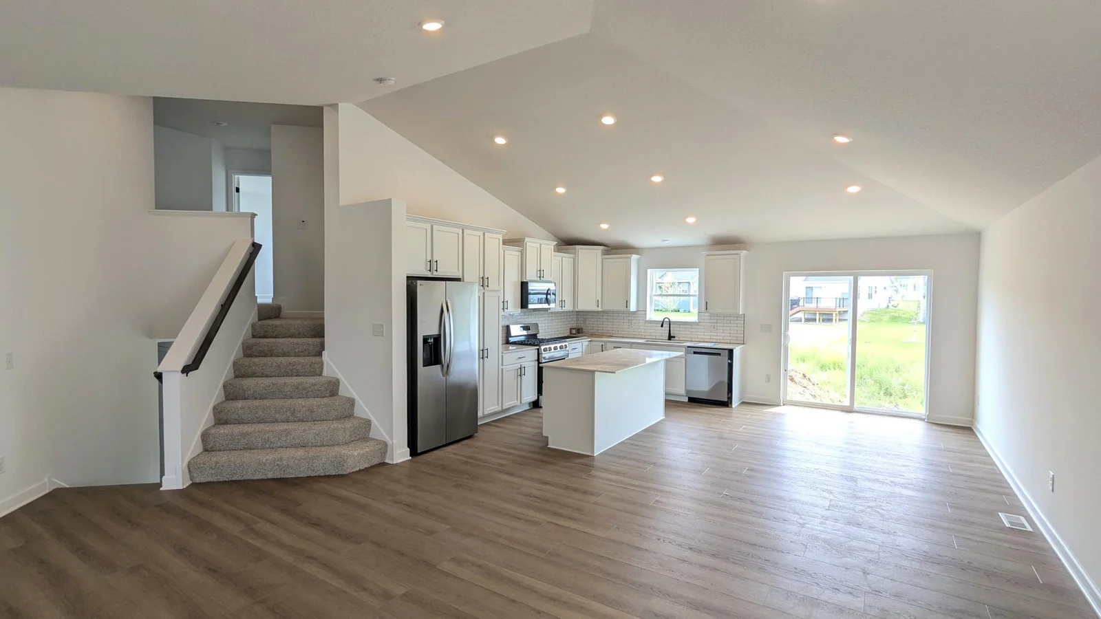 Photo of the actual home as of 6.29! The modern kitchen seamlessly connects to a bright dining area and the rest of the main level.