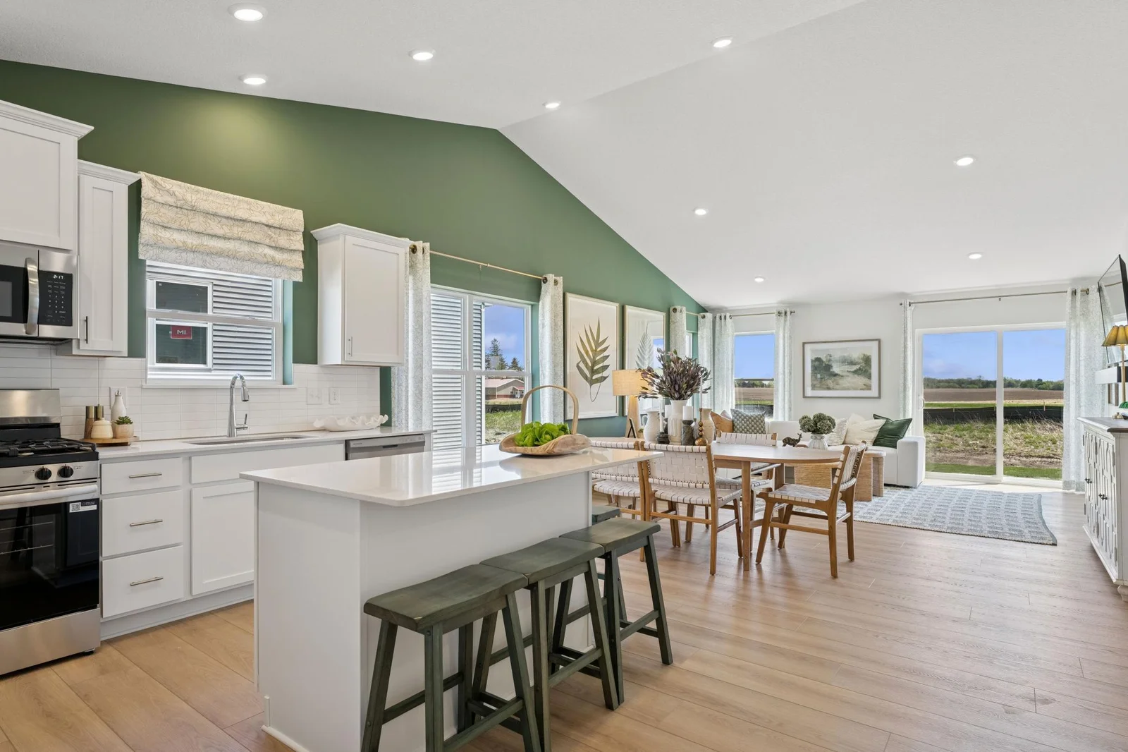 (Photo of a model home. Finishes and features will vary) The vaulted ceilings make this open-concept layout feel very spacious!