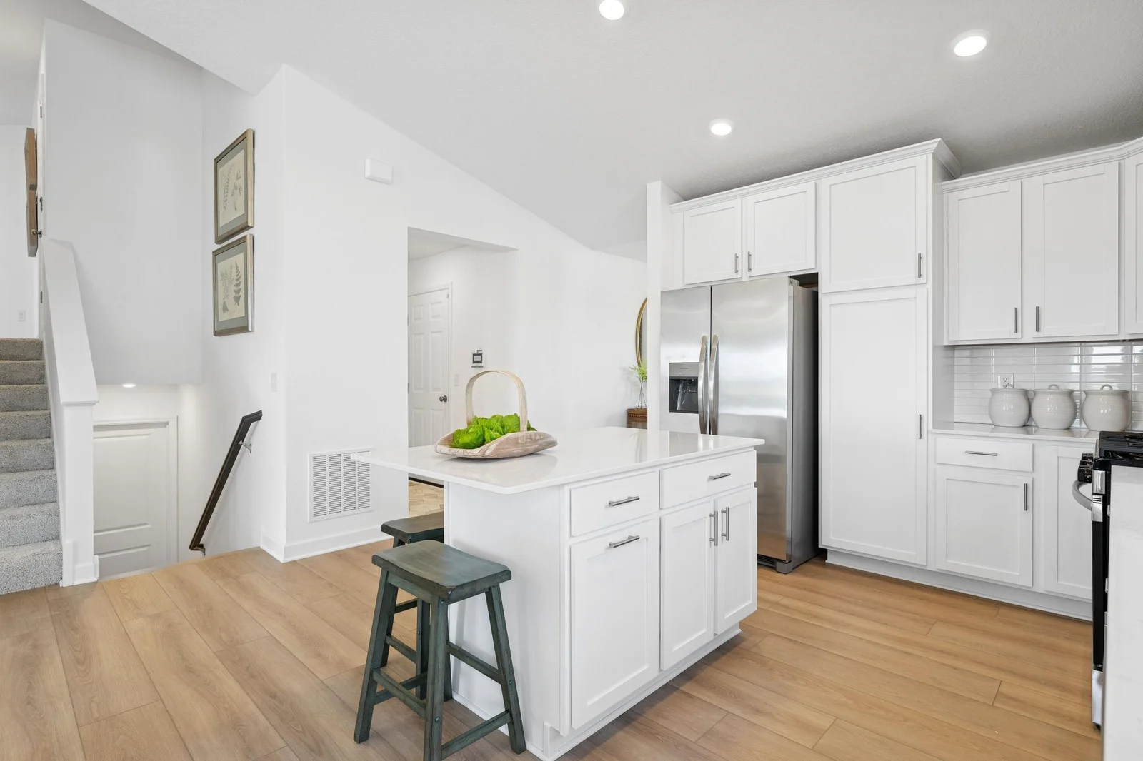 (Photo of a model home. Finishes and features will vary) The kitchen island anchors the kitchen.
