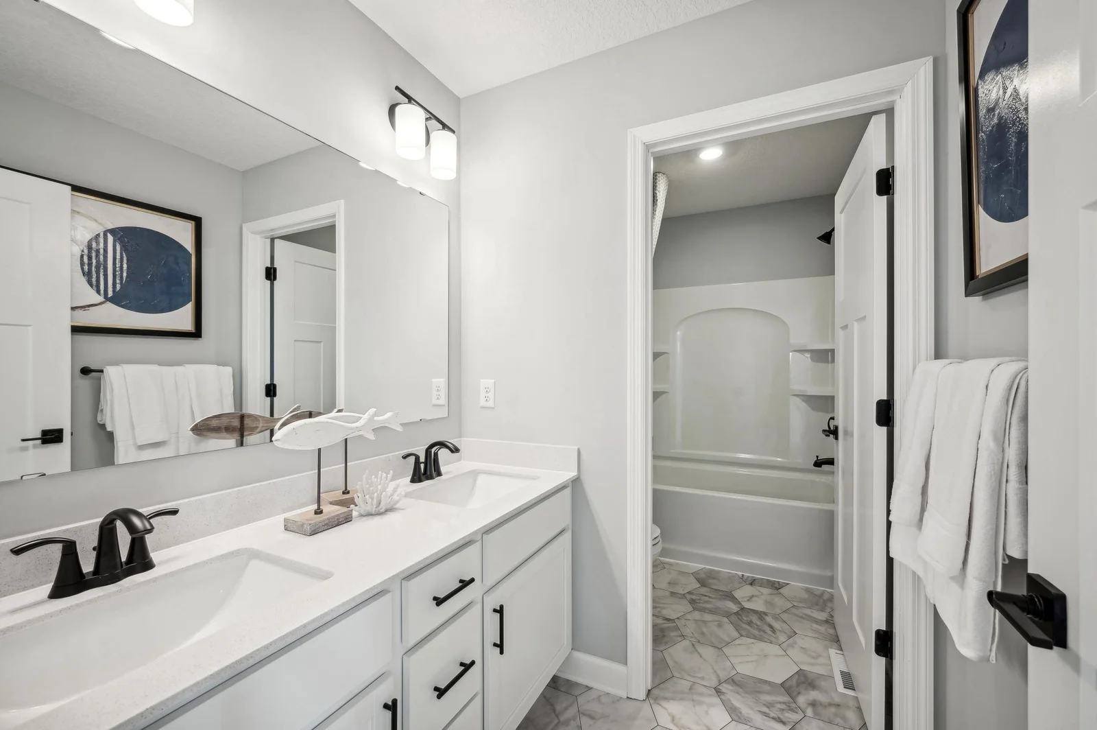 (Photo of a decorated model, actual homes finishes will vary) The secondary bath on the upper level provides the perfect amount of space!