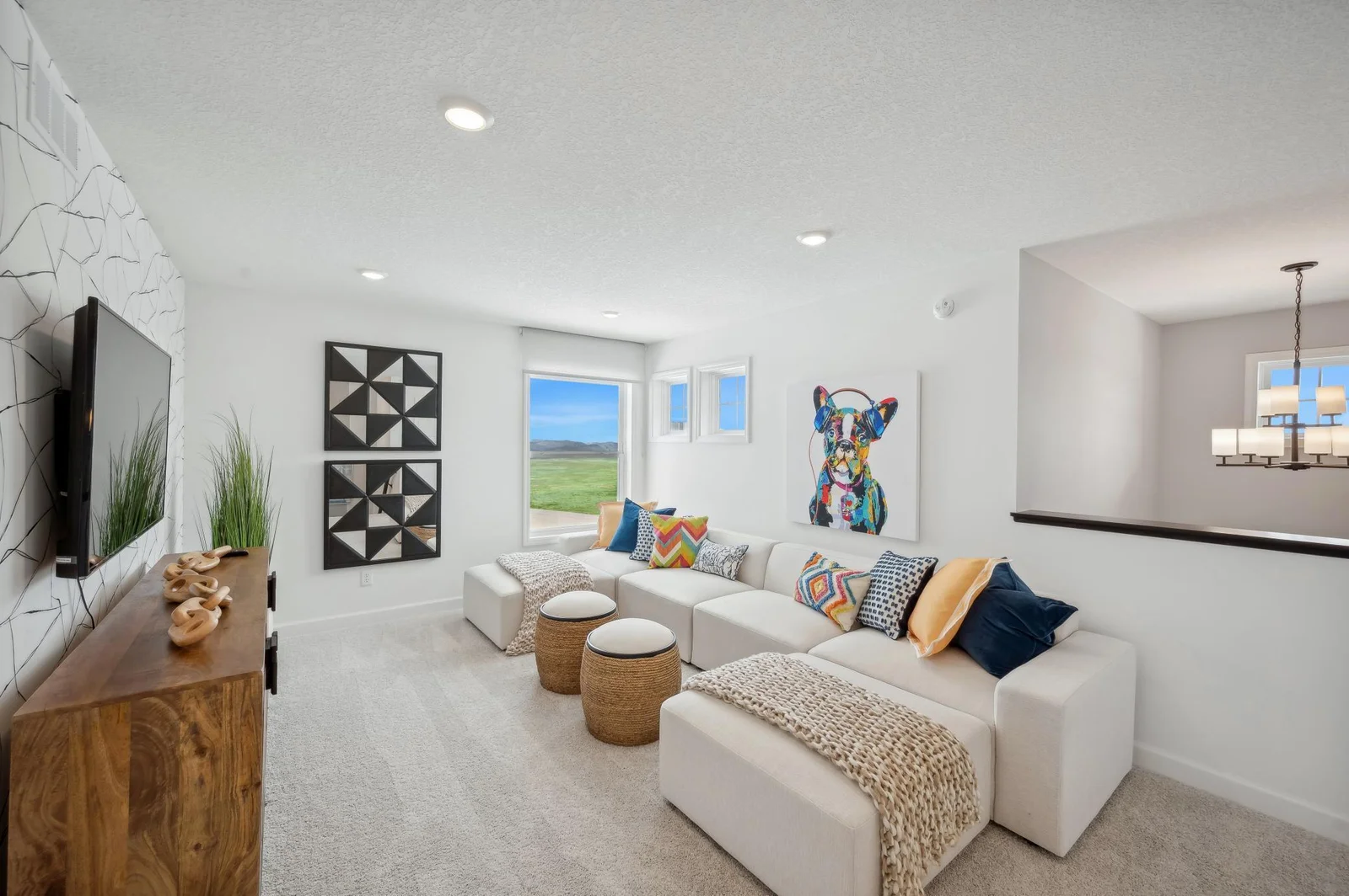 (Photo of a decorated model, actual homes finishes will vary) Located on the upper level, this perfectly sized living space has enough room for a desk, television and seating for all. Plus, it is just steps away from all four upper level bedrooms.