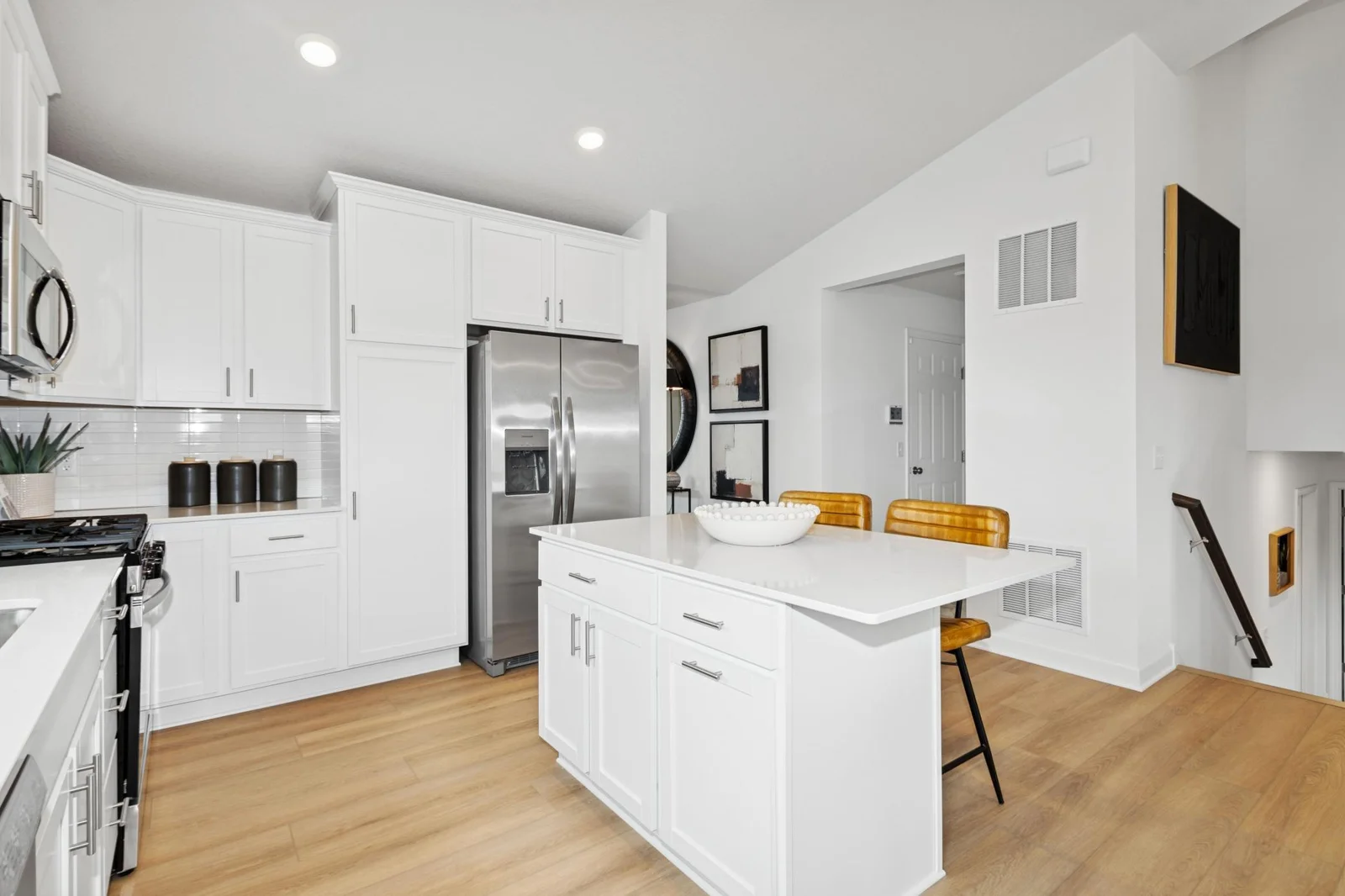 *Photo of model home, actual features may vary. This thoughtfully-designed kitchen layout features stainless steel appliances and quartz countertops.