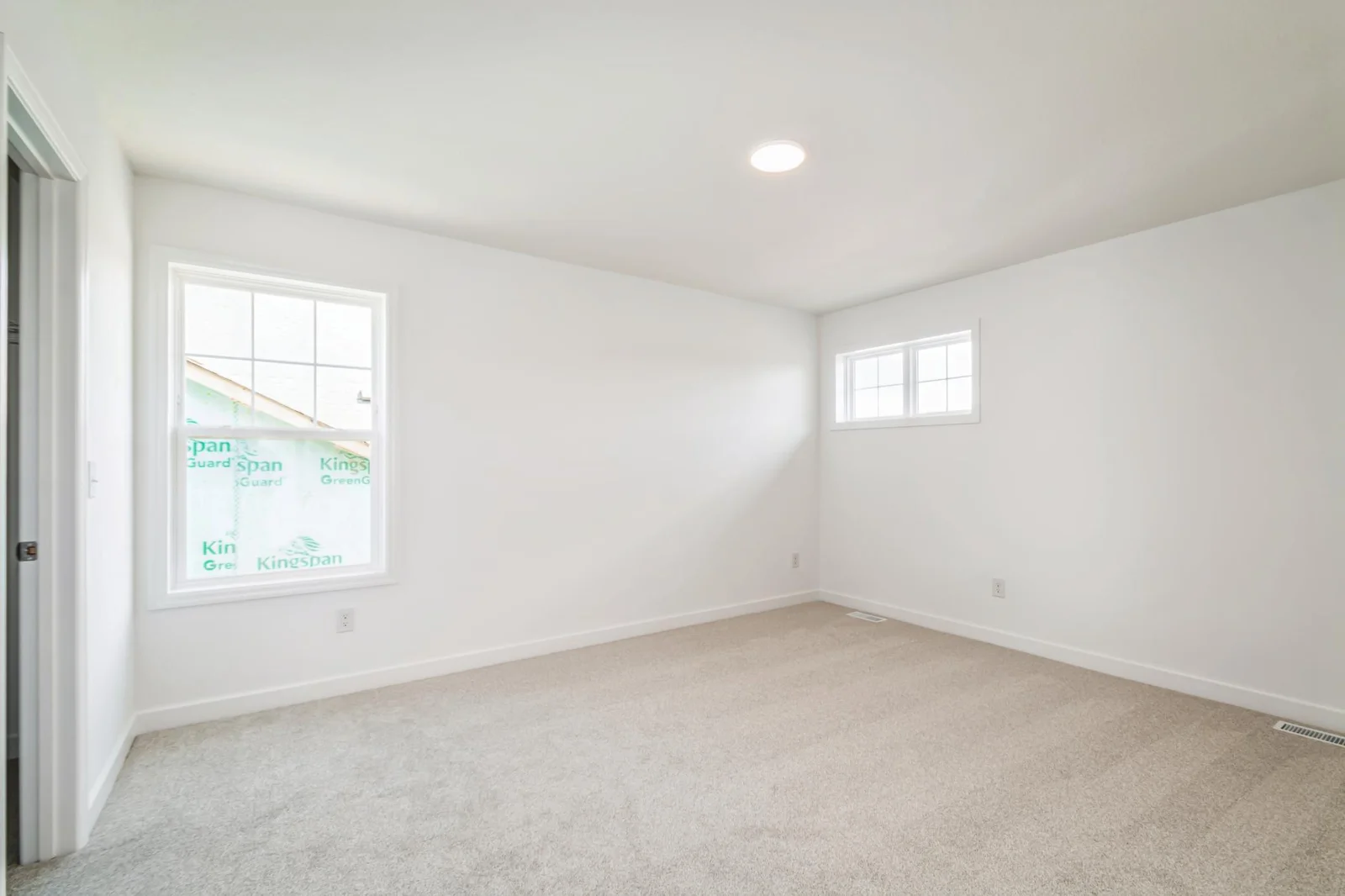 Photo is of the actual home. One of three secondary bedrooms.