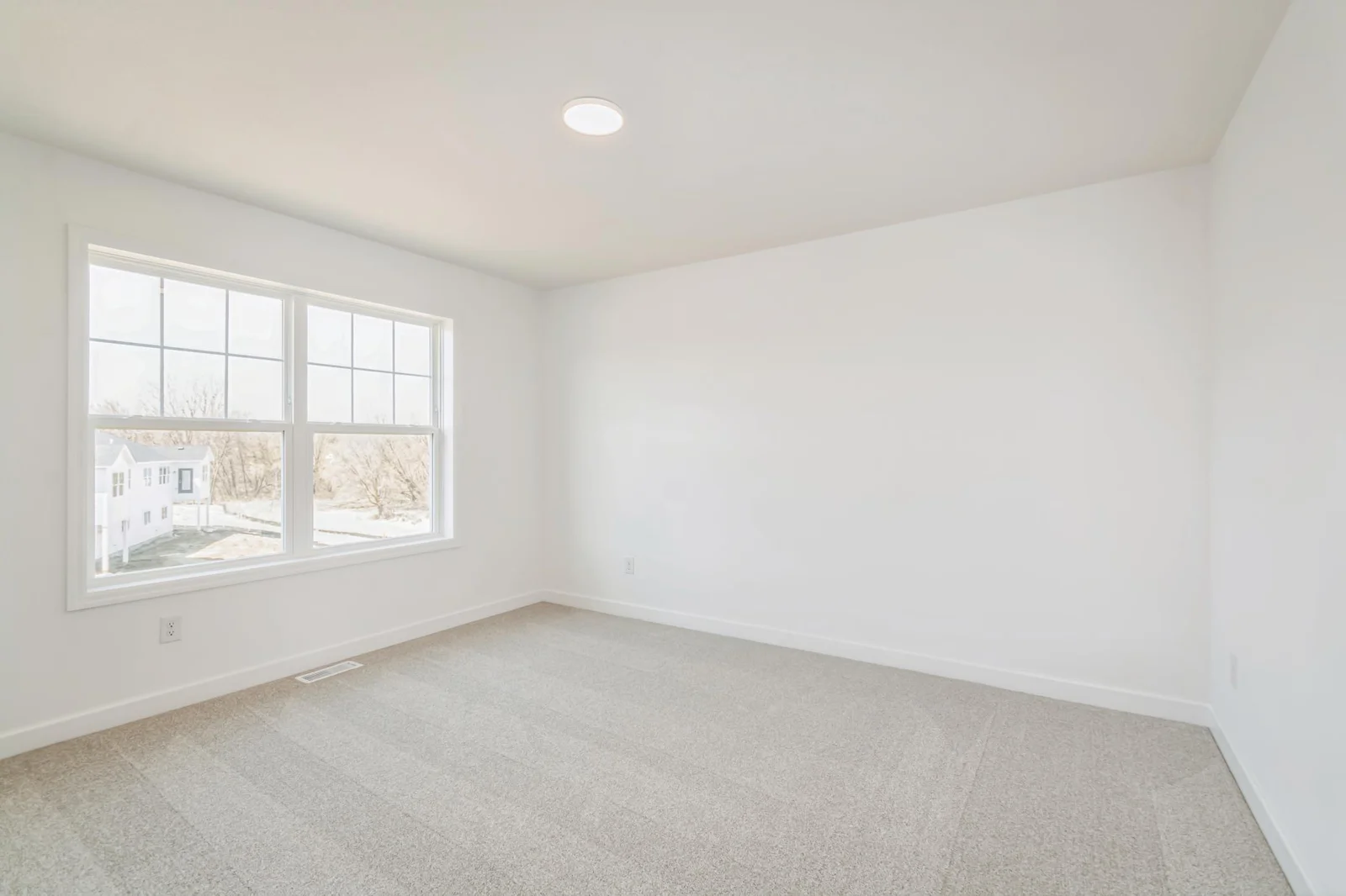 Photo is of the actual home. One of three secondary bedrooms.