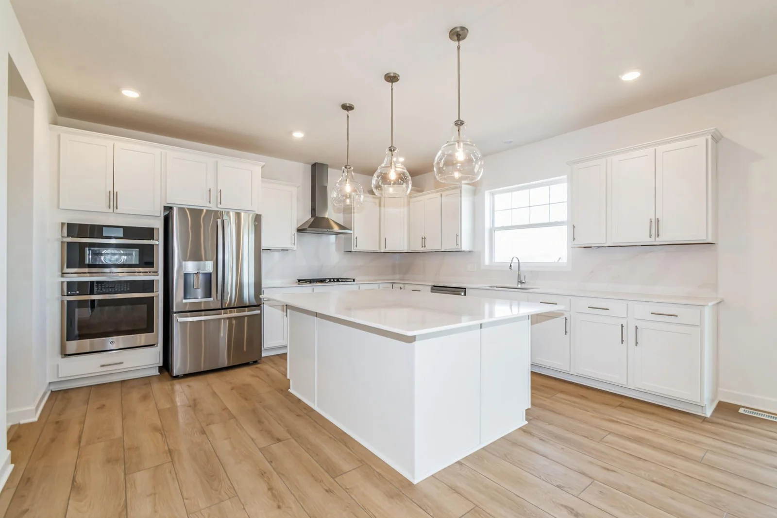 Photo is of the actual home. The Washburn offers a gourmet kitchen with Frigidaire professional appliances, quartz countertops, soft close cabinets, under cabinet lighting and walk in pantry.