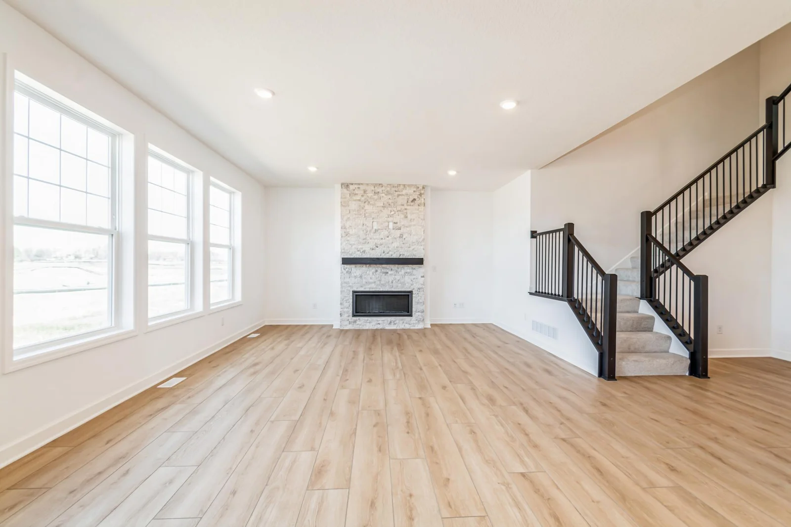 Photo is of the actual home. Cozy up next to the fireplace in your new great room!