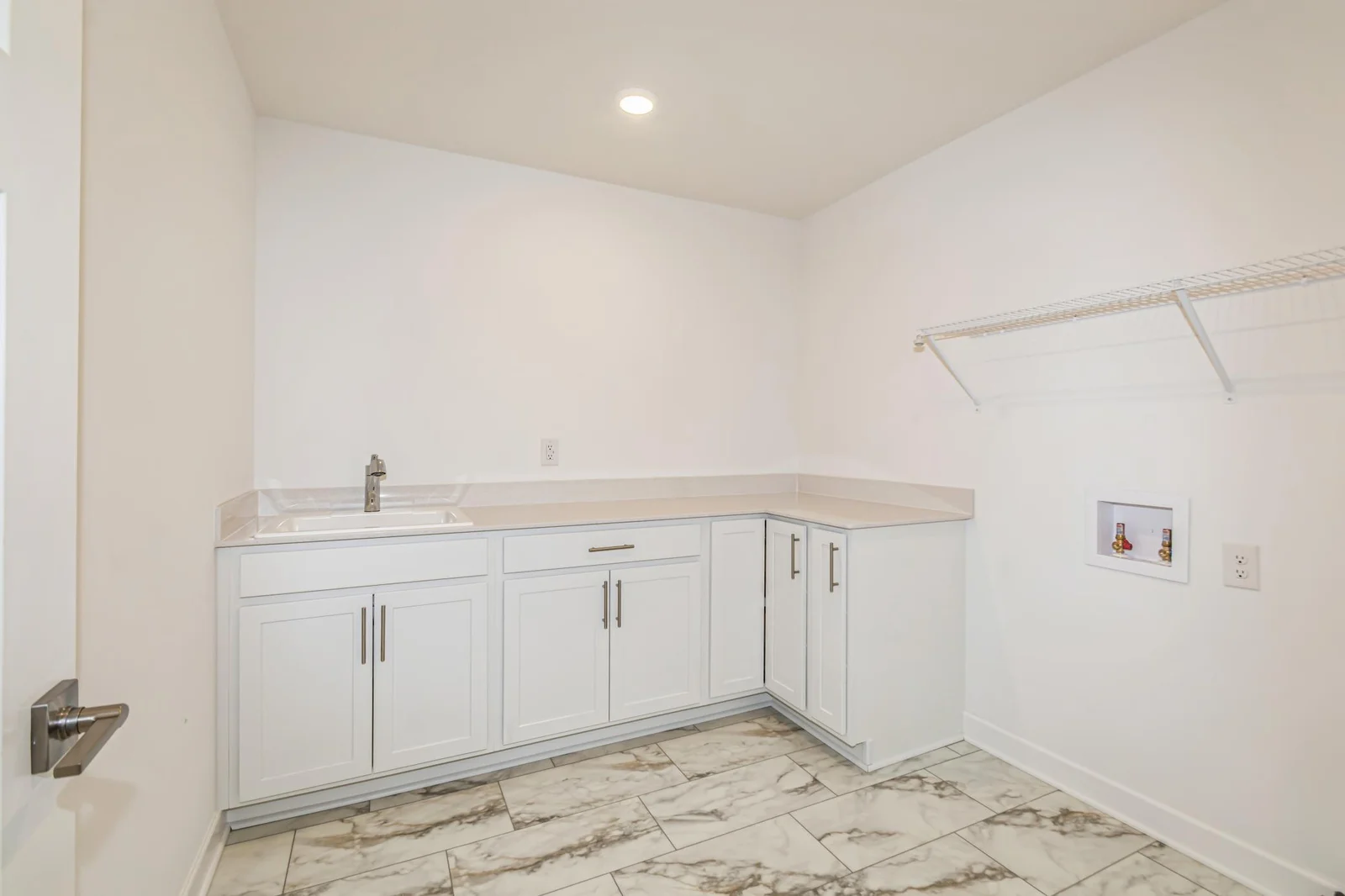 Photo is of the actual home. The upper level laundry room.