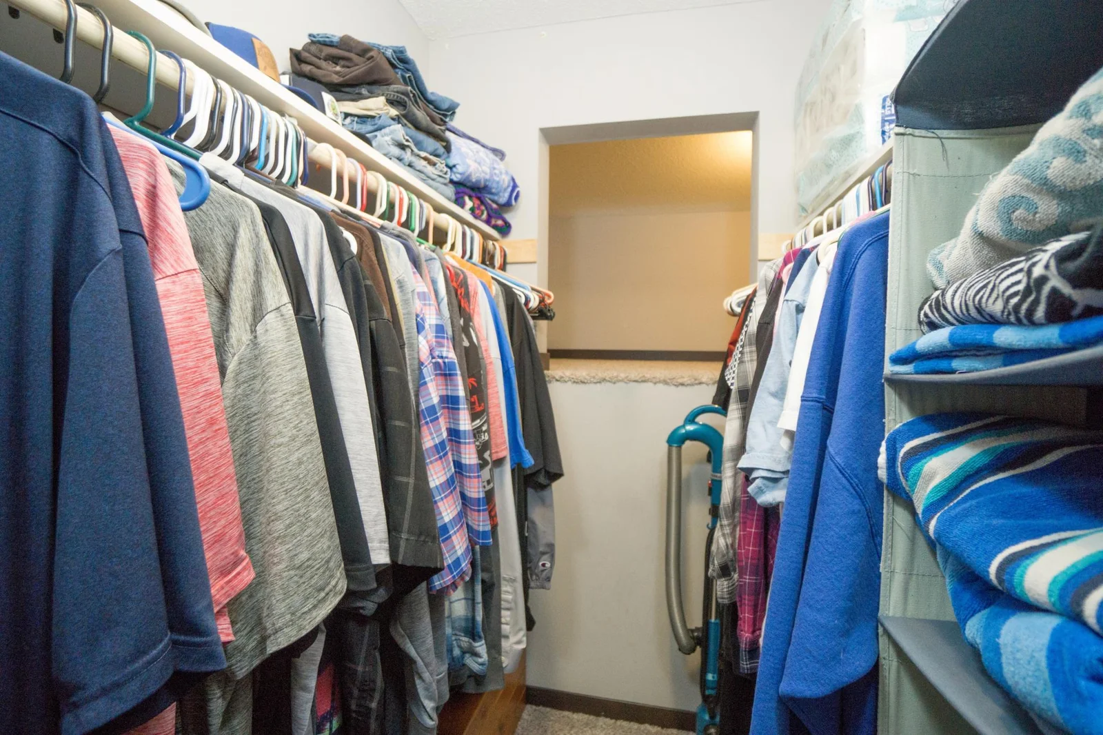 Owners walk-in Closet with adjacent storage loft
