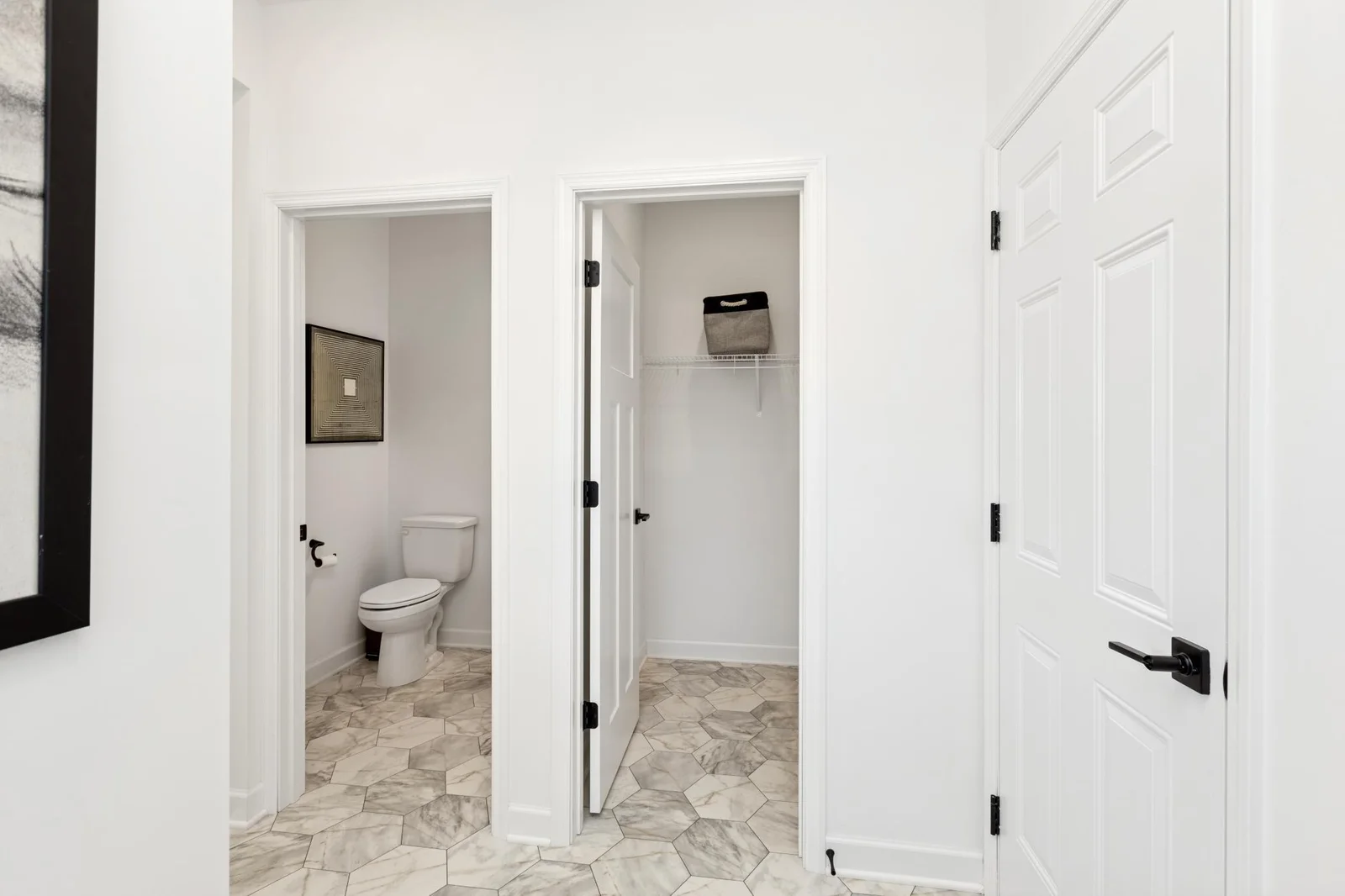(Photo of a decorated model home, features and finishings will vary) A storage closet and a half-bath are located next to the mudroom.