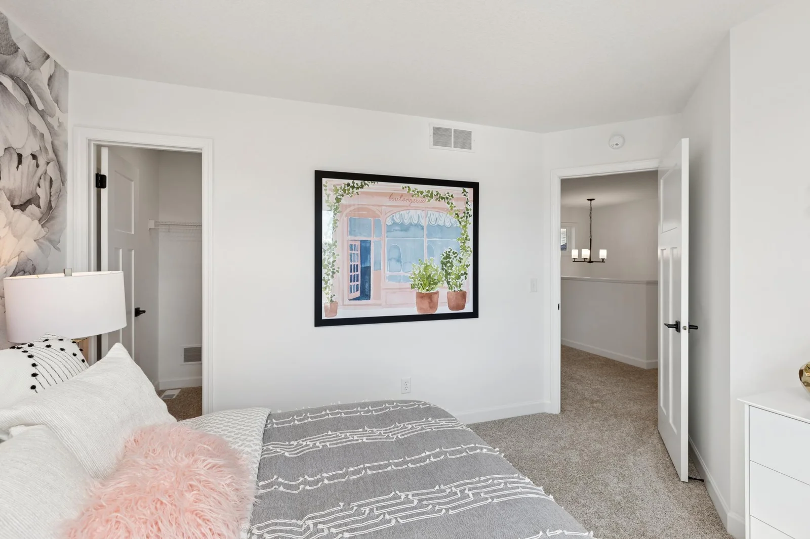 (Photo of a decorated model home, features and finishings will vary) One of the spacious secondary bedrooms, featuring a walk-in closet.