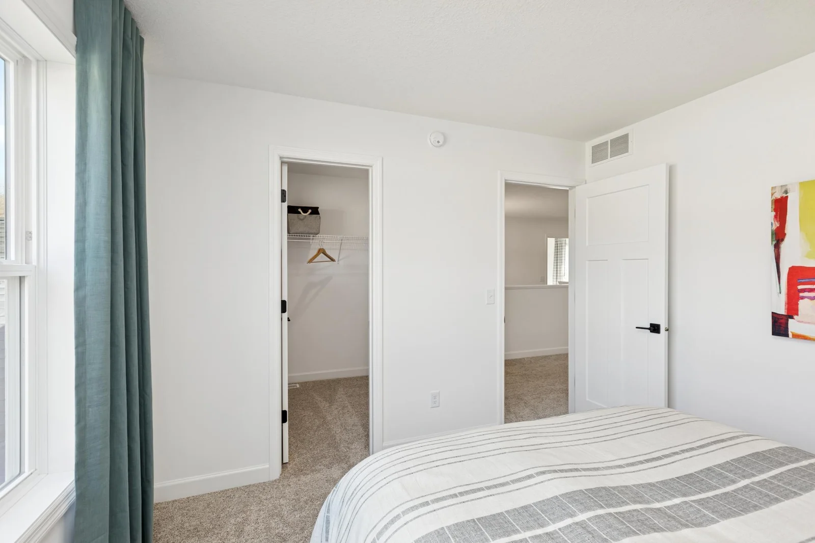 (Photo of a decorated model home, features and finishings will vary) One of the spacious secondary bedrooms, featuring a walk-in closet.