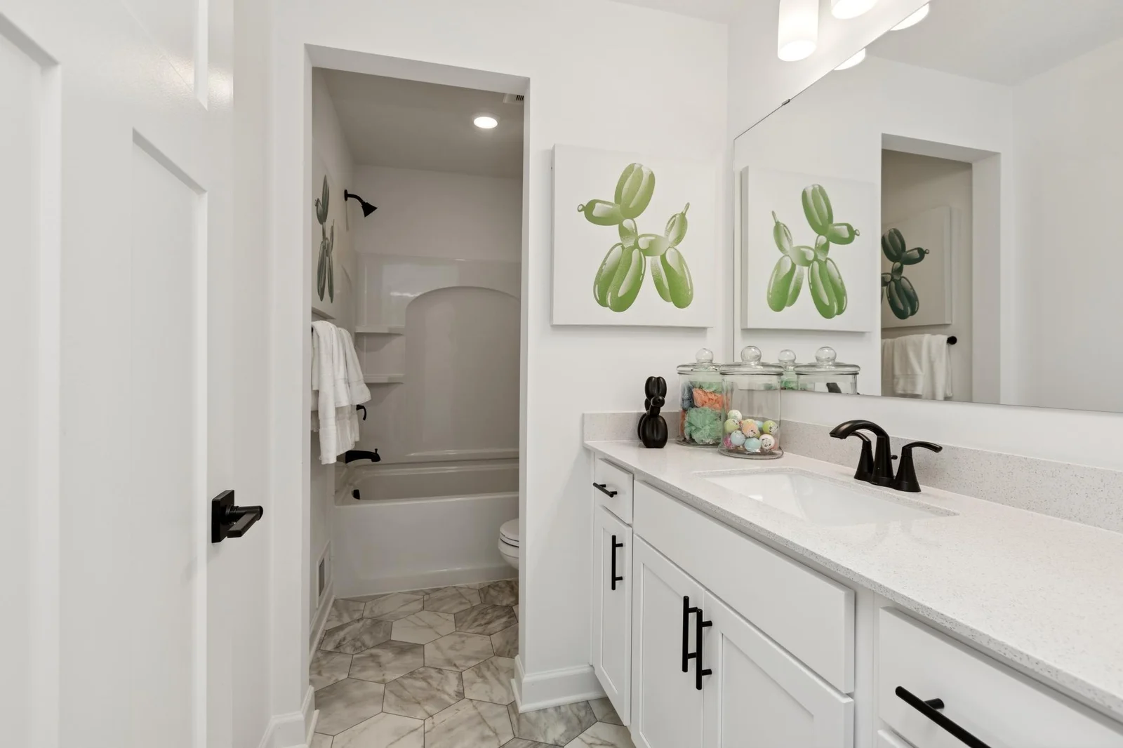 (Photo of a decorated model home, features and finishings will vary) The full upper level bathroom.