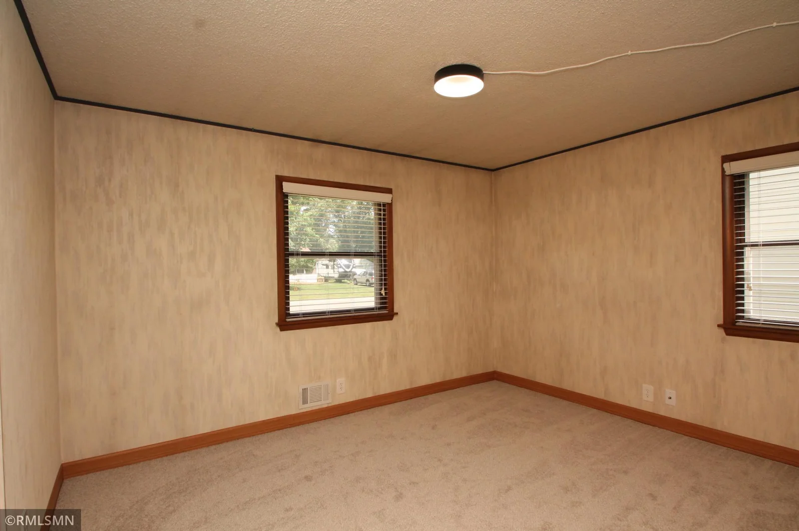 Big primary bedroom with new carpet and trim.