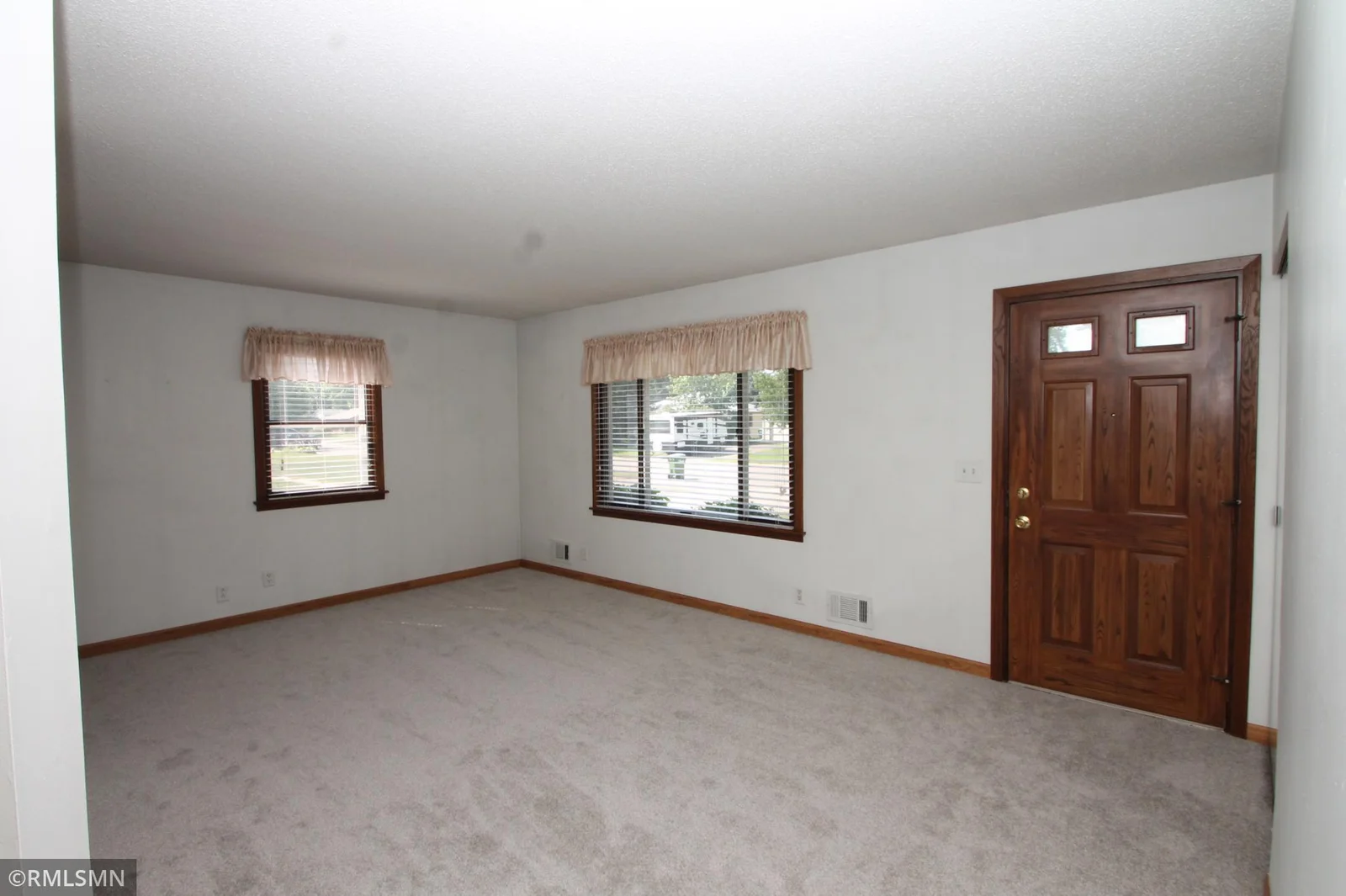 Nice windows and window treatments.  Handsome front door.