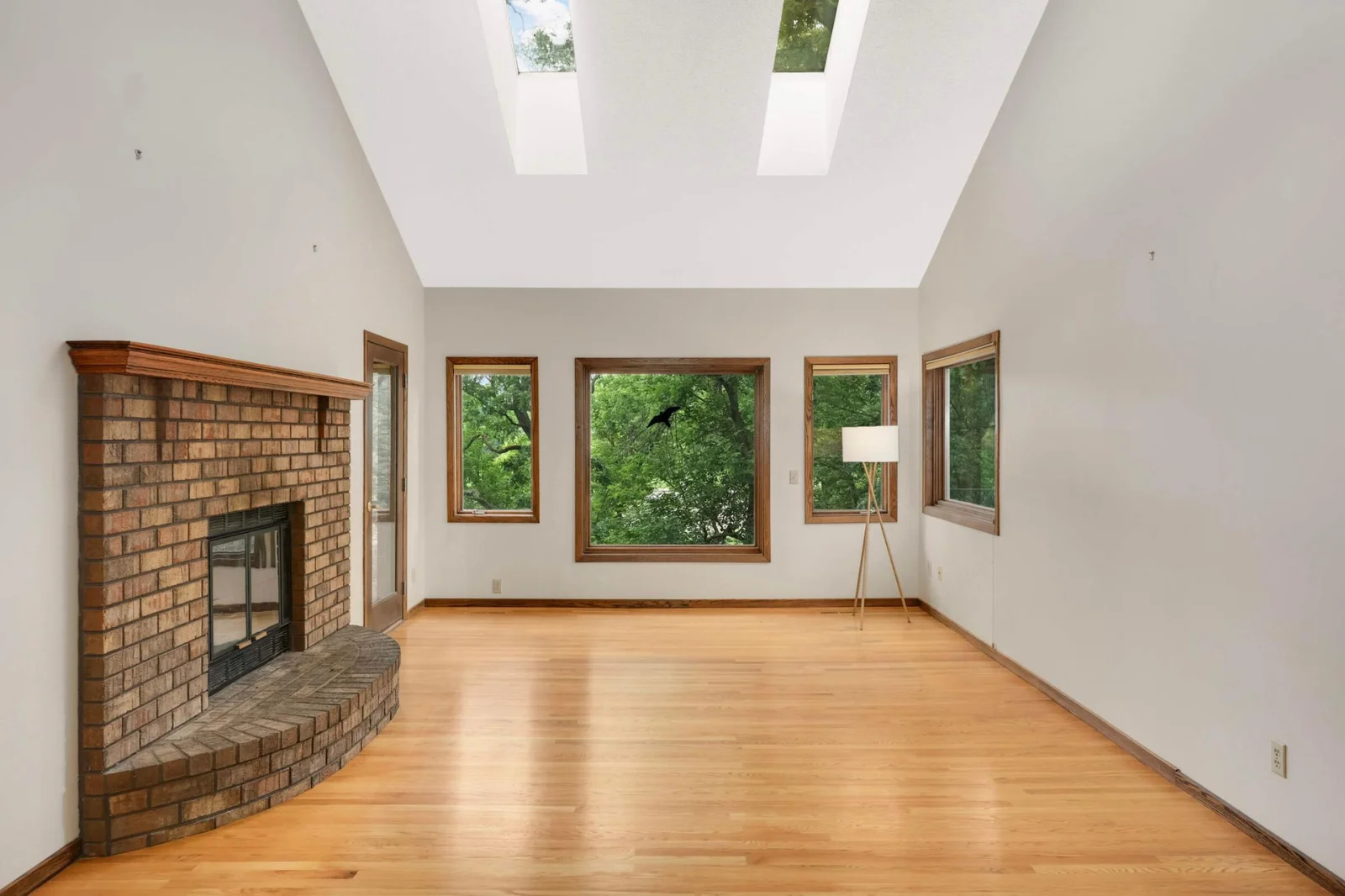 Skylights and large windows create beautiful light in the living room and upper hallway