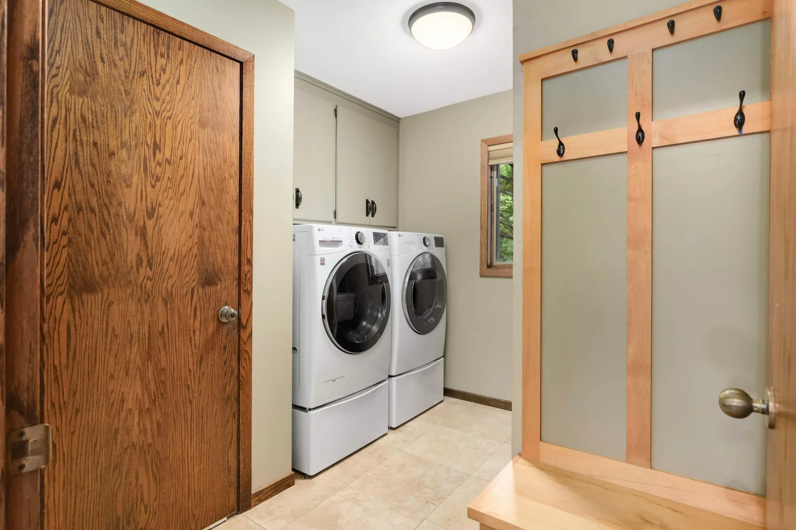 Coat area and laundry room off kitchen - door pictured leads to the oversized garage with EV plug
