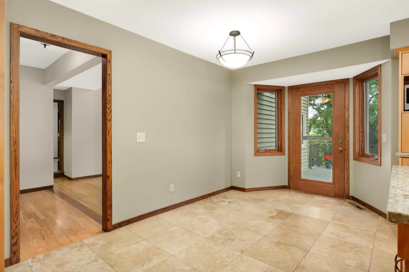Glass door from kitchen eat-in area leads to large deck