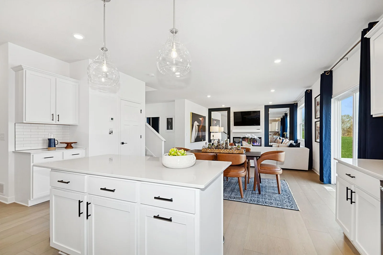 (Photo of a decorated model, actual homes finishes will vary) The dining area is soaked in sunlight.