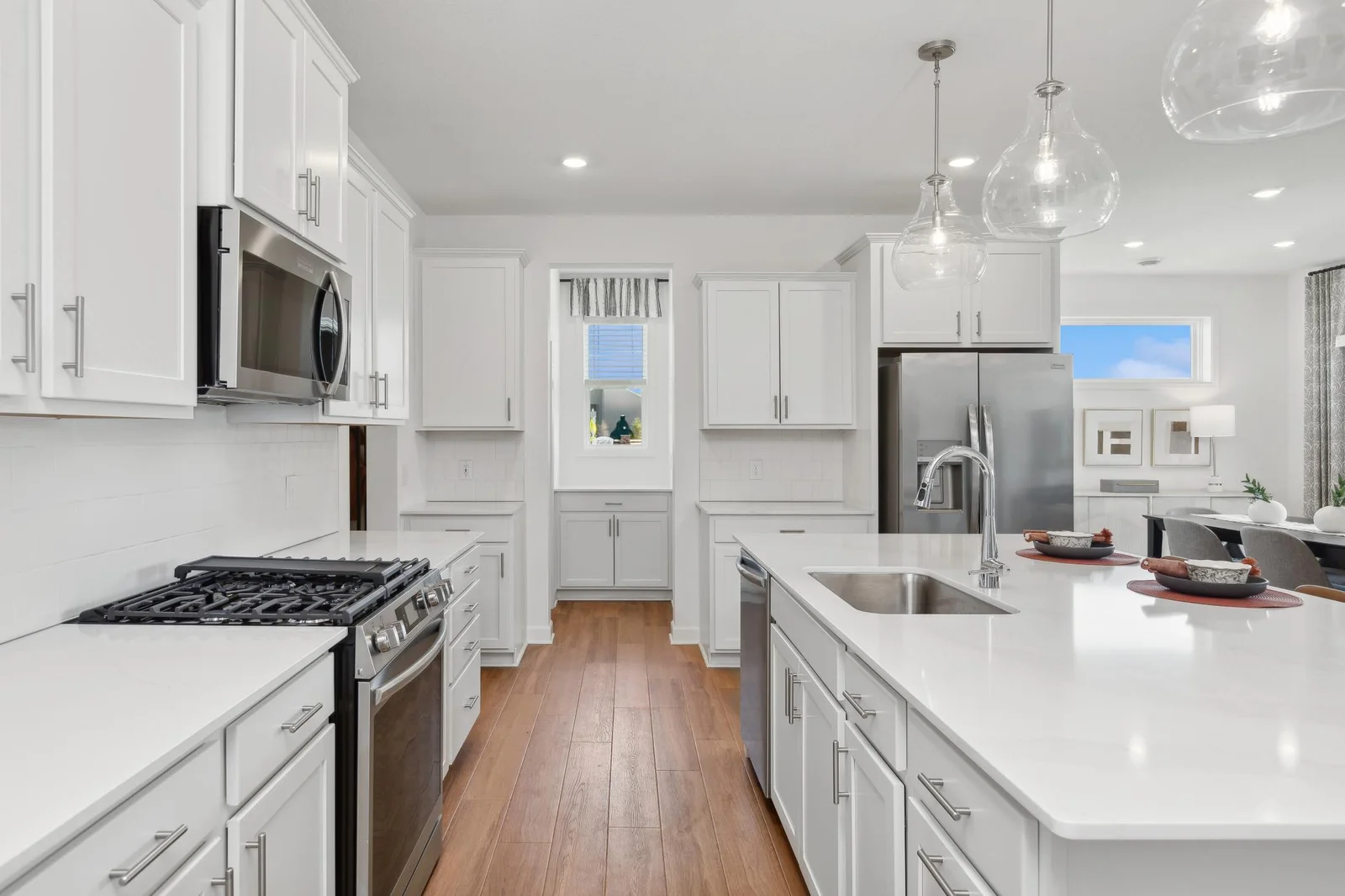 *Photo of model home, actual features may vary. This thoughtfully-designed kitchen layout features stainless steel appliances and quartz countertops.
