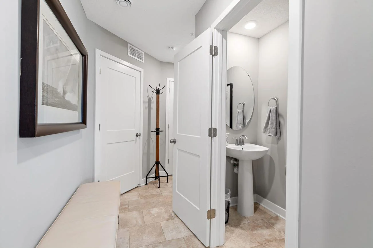 (Photo of a decorated model, actual homes finishes will vary)  (Photo of decorated model, actual home's finishes vary) Conveniently located powder bath on the main level.