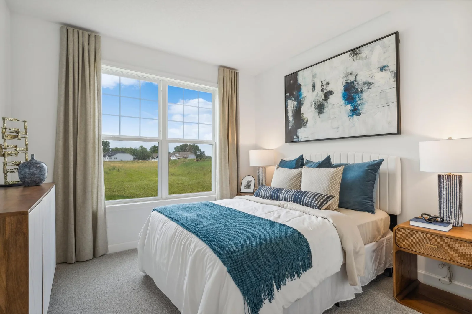 (Photo of a decorated model, actual homes finishes will vary) Main level bedroom.