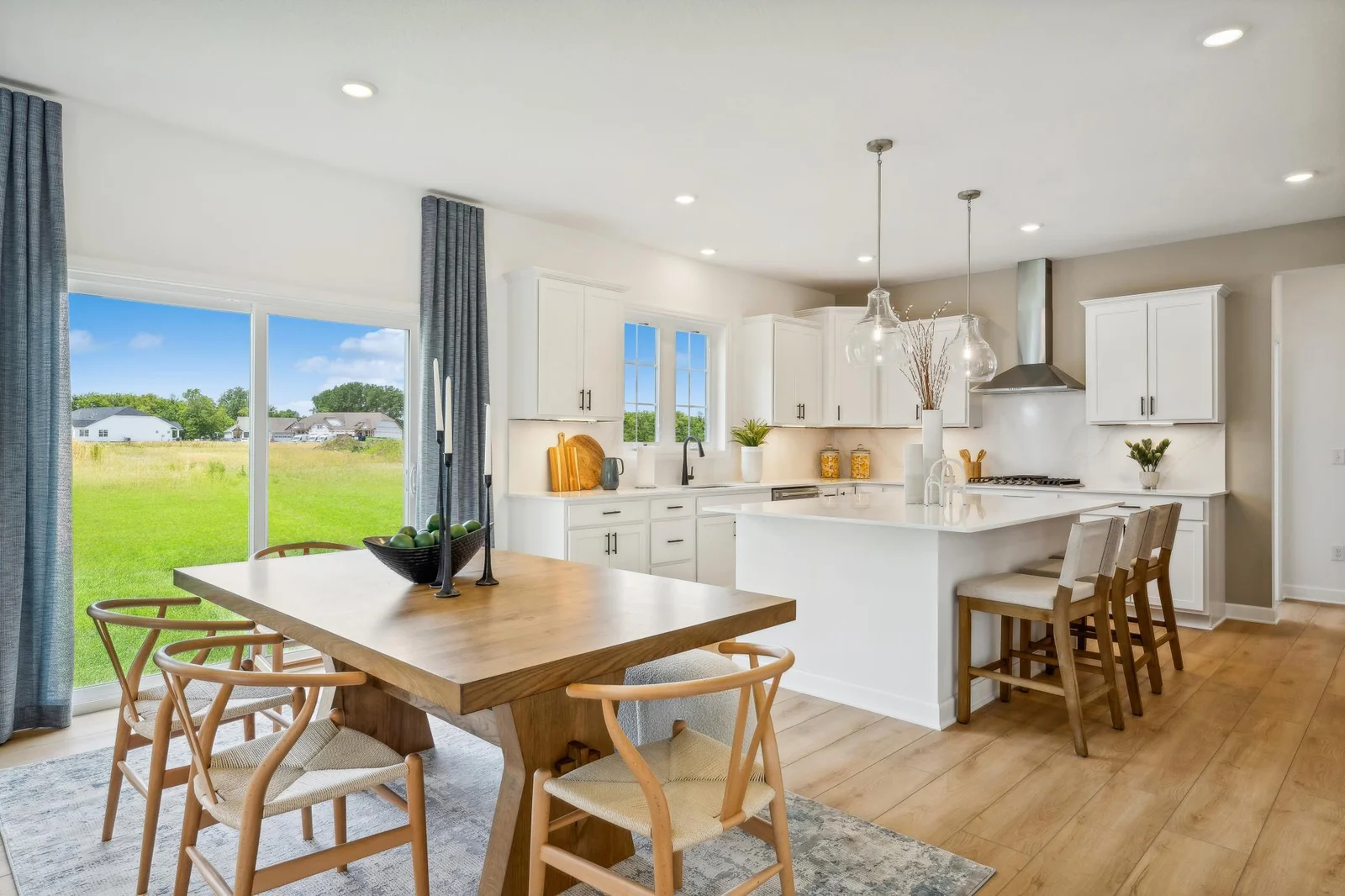 (Photo of a decorated model, actual homes finishes will vary) Soaked in natural sunlight, the homes eat-in dining room has ample space for a dining table located in the heart of the home.
