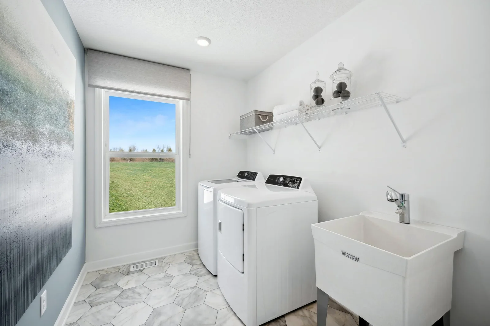 (Photo of a decorated model, actual homes finishes will vary) Conveniently located on the second level, this plan features upper-level laundry right next to the home's bedrooms. Note: appliances are not included.