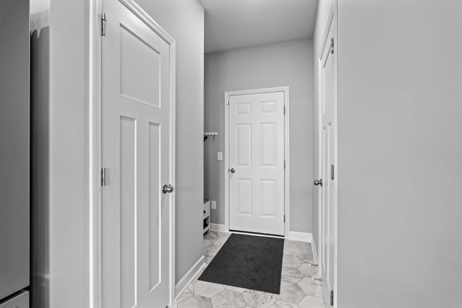 The home includes a spacious attached two-car garage, providing ample room for parking and additional storage. Just inside the garage entrance, you'll find a convenient entryway with a coat closet—perfect for storing outerwear and shoes.