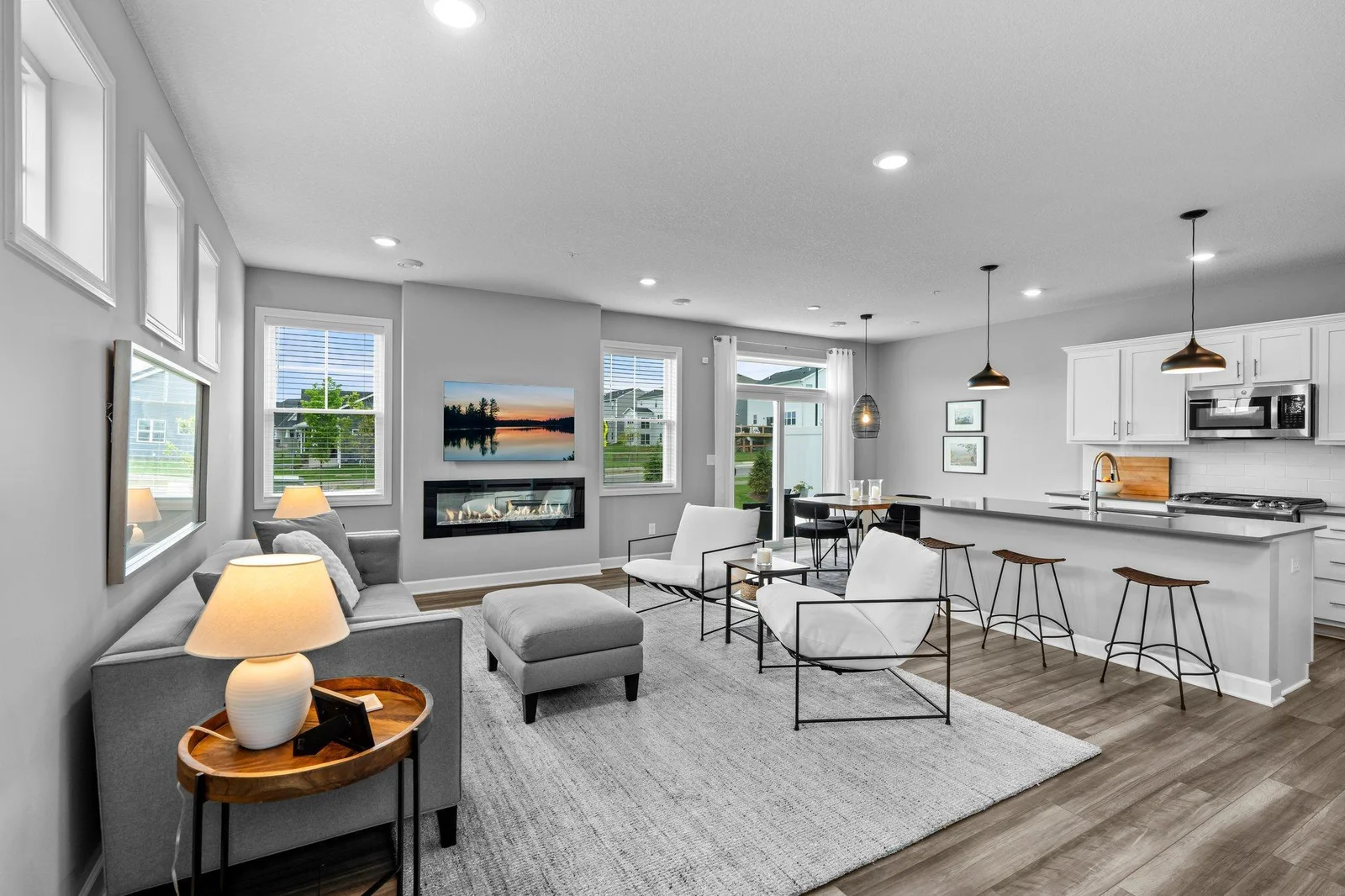 The main-level living room, seamlessly connected to the kitchen and dining area, offers the perfect setting for both relaxing and entertaining.