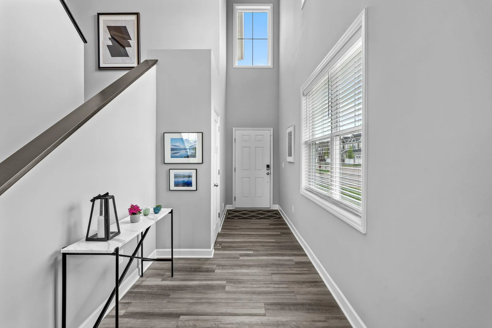 As you step inside, you're greeted by a grand foyer with soaring 18-foot ceilings, setting the tone for the open and airy feel of the home.