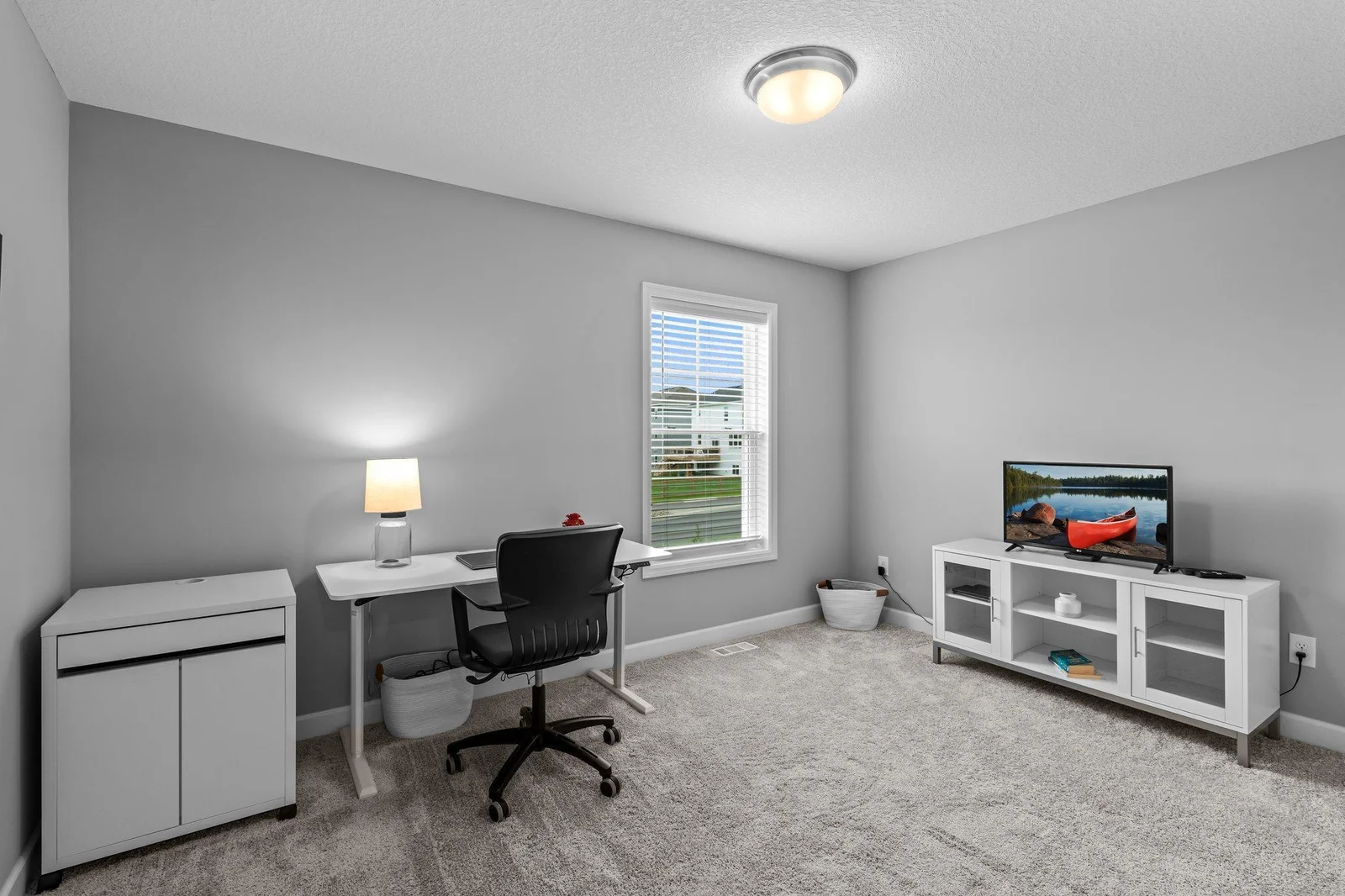 A view of Bedroom Three, featuring cozy carpeting, ample closet space, and a rear-facing window. All upstairs bedrooms are conveniently located just steps from the shared full bathroom.