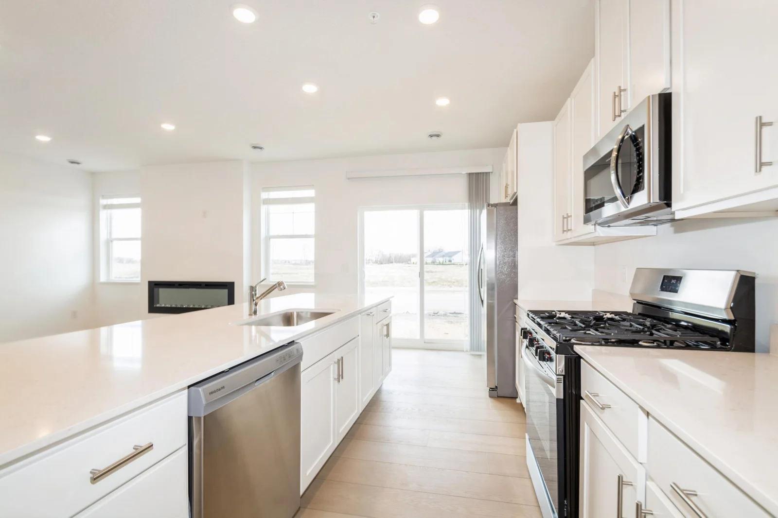 (This is a photo of a similar home!) The expansive kitchen area transitions seamlessly into the open and spacious living room area.