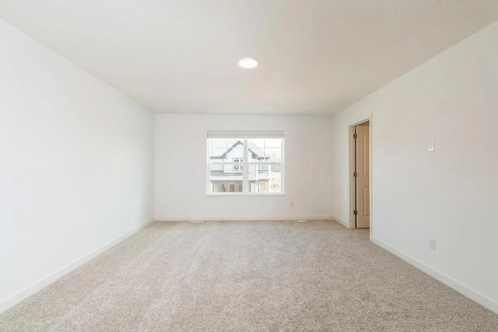 (This is a photo of a similar home!) Welcome to the spacious primary bedroom - full of stunning natural sunlight!