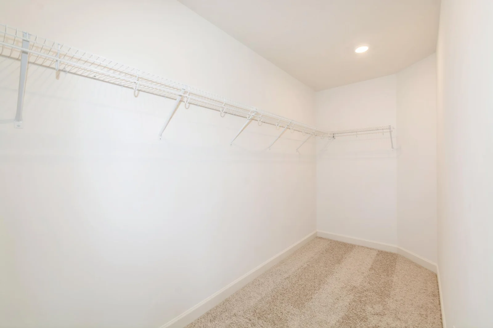 (This is a photo of a similar home!) The walk-in closet in the primary bedroom.
