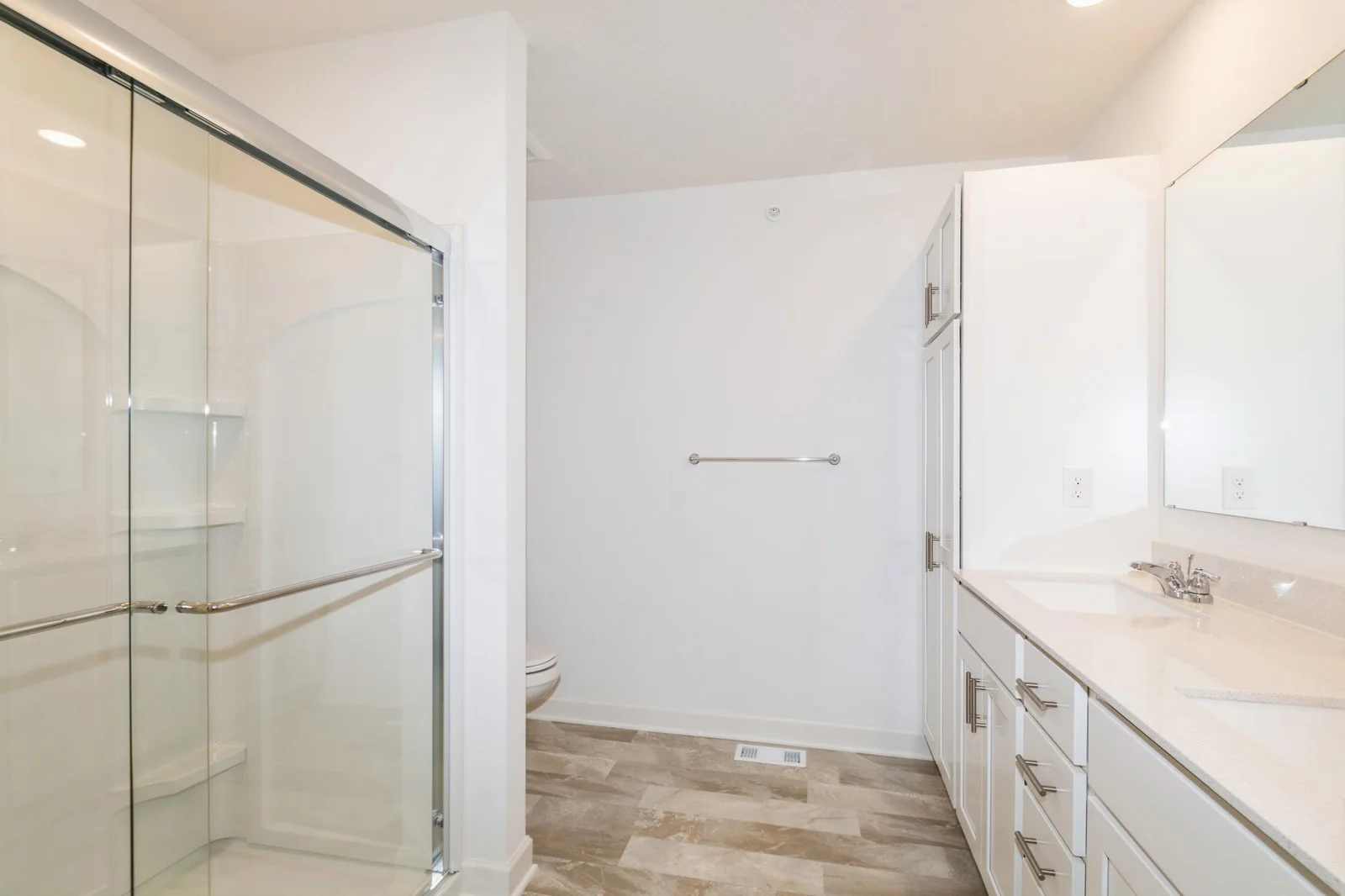 (This is a photo of a similar home!) The spacious primary ensuite bathroom offers a large double vanity.