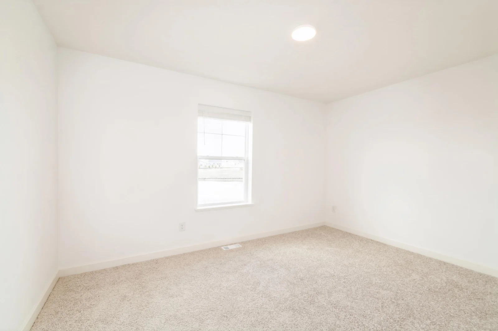 (This is a photo of a similar home!) The third bedroom.
