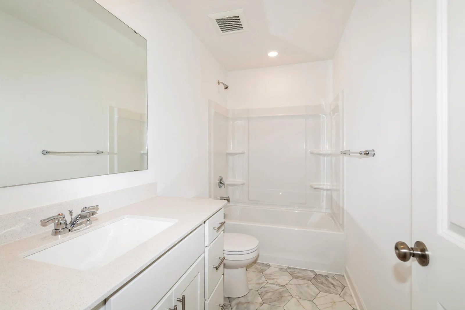 (This is a photo of a similar home!) The full secondary bathroom.