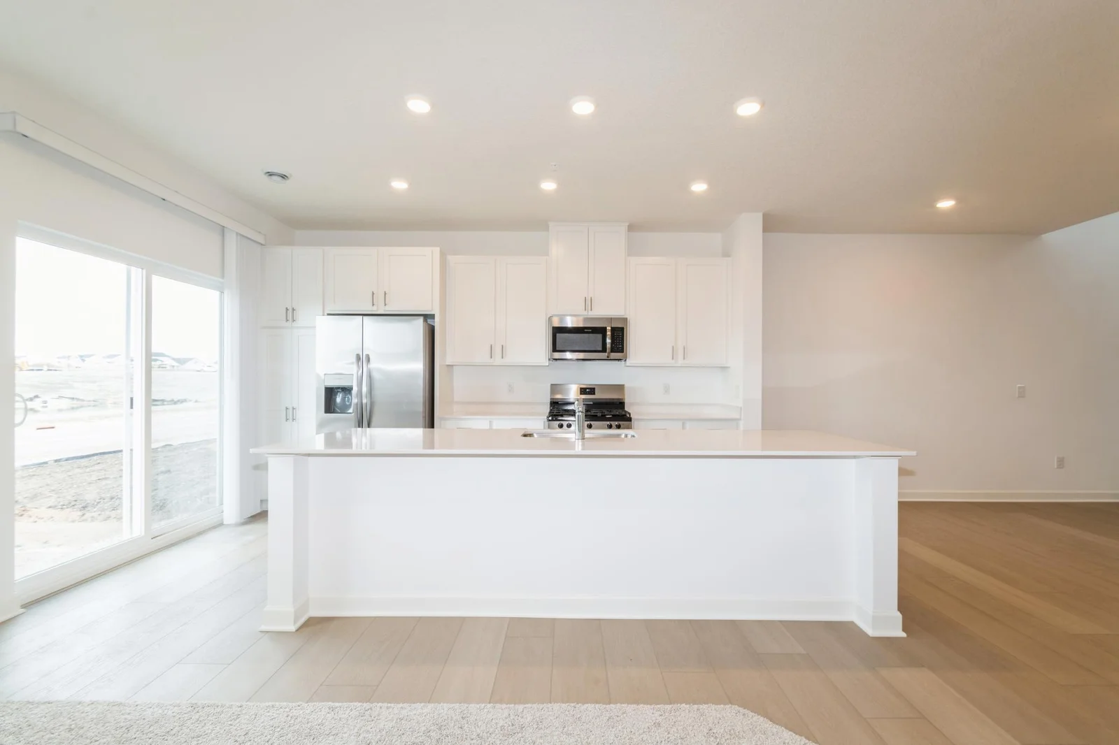 (This is a photo of a similar home!) This spacious kitchen features a large center island, stainless appliances and more.