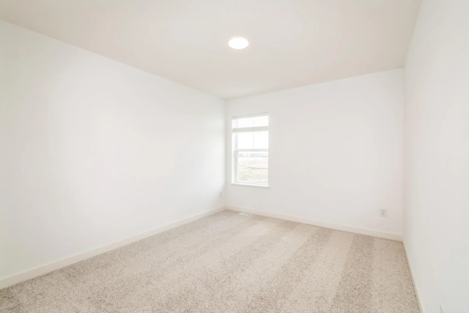 (This is a photo of a similar home!) The second bedroom.