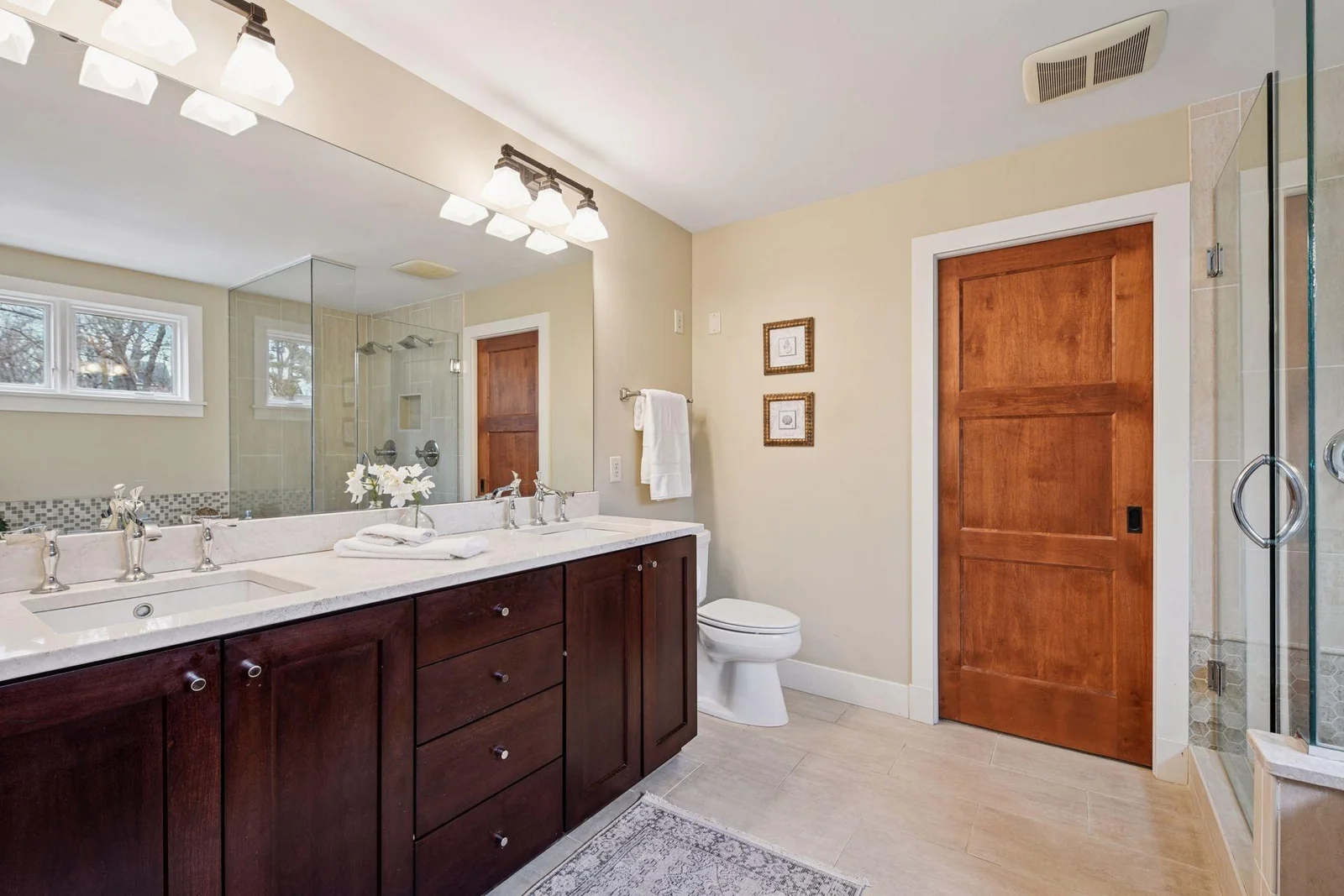 The primary ensuite with tile floors, double vanity and separate shower and tub is resort worthy.