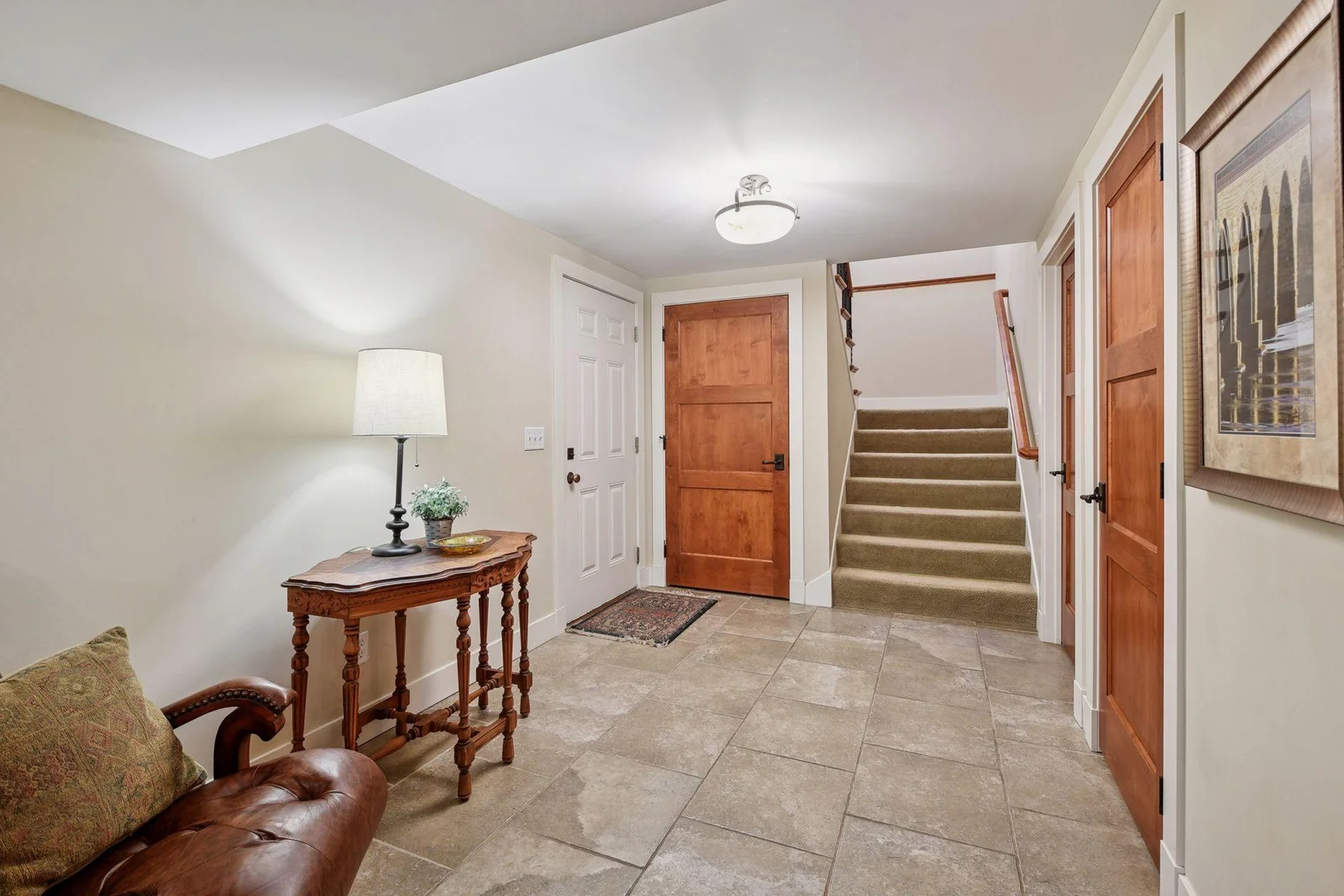 The garage entry into the lower level is conveniently located. Those three doors - all lead to large storage areas!