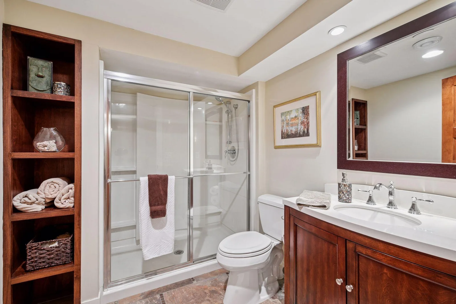 3/4 bath in the lower level has tile floors, new shower head and plenty of storage.