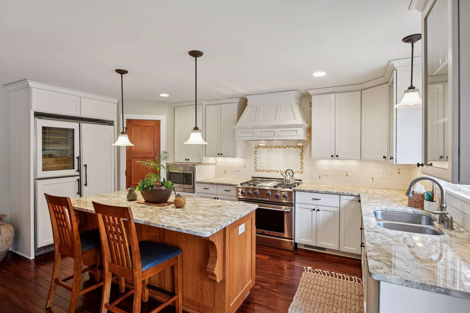 Updated kitchen with a great center island, pantry and gleaming countertops.