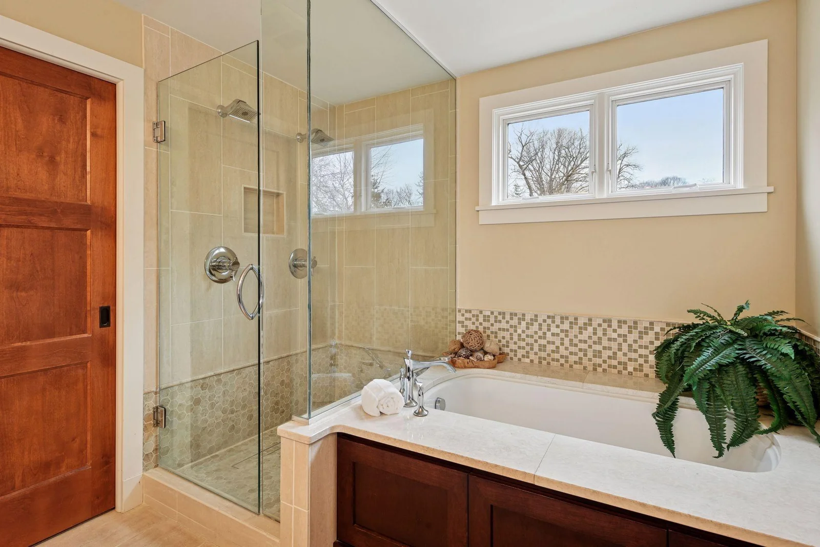 Soaker tub and shower with dual showerheads.