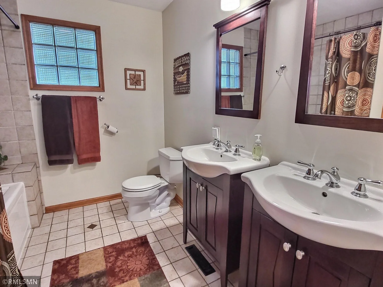 The main floor full bath consists of tile floor and tile surround the tub and shower, dual sinks located conveniently next to the primary bedroom.