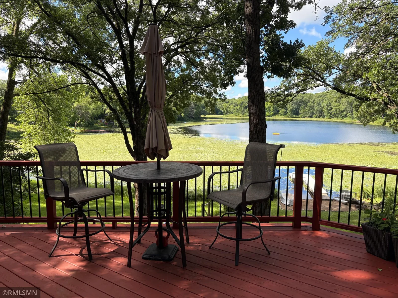 Outdoor living shines here with two distinct entertainment areas perfect for hosting family and friends—or simply savoring quiet moments by the lake..